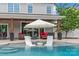 Gorgeous backyard featuring a pool with in-pool loungers, umbrella seating and covered patio at 106 Wrangler Dr, Mooresville, NC 28115