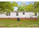 View of the exterior featuring the side of the home with vinyl siding and brick foundation with a grassy yard at 1106 3Rd Sw Ave, Hickory, NC 28602