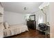 Neat bedroom area features a bed, desk, dark wood dresser, and wood-look flooring at 1106 3Rd Sw Ave, Hickory, NC 28602