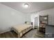 Cozy bedroom with a grey bed frame, neutral bedding, mirror, and wood floors at 1106 3Rd Sw Ave, Hickory, NC 28602