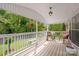 Inviting covered front porch with charming decor and scenic views of the landscaped front yard at 1106 3Rd Sw Ave, Hickory, NC 28602