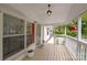 Covered front porch, features white railings, hanging plants, and a view of the charming neighborhood at 1106 3Rd Sw Ave, Hickory, NC 28602