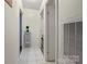 Hallway with white tile floors and view of a bedroom at the end of the hall at 1106 3Rd Sw Ave, Hickory, NC 28602