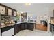 Kitchen featuring a dishwasher, dark cabinets, and mosaic tile backsplash, with dining room in view at 1106 3Rd Sw Ave, Hickory, NC 28602