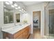 Elegant bathroom with double vanities, a large mirror, and a glass-enclosed shower at 1116 Brooksland Pl, Waxhaw, NC 28173
