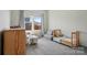 Comfortable bedroom with window and a cozy setup for a , including a crib and a small desk at 1116 Brooksland Pl, Waxhaw, NC 28173
