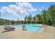 Large community pool with lounge chairs and mature trees, perfect for hot summer days at 1116 Brooksland Pl, Waxhaw, NC 28173
