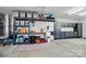 Well-organized garage featuring custom storage solutions and a convenient utility sink at 1116 Brooksland Pl, Waxhaw, NC 28173