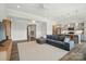Spacious living room open to the kitchen with modern appliances and eat-in island and a gray L-shaped couch at 1116 Brooksland Pl, Waxhaw, NC 28173