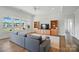 Spacious living room filled with natural light, featuring built-in shelving and a comfortable sofa at 1116 Brooksland Pl, Waxhaw, NC 28173