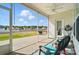 Inviting screened porch with ceiling fan and view of spacious backyard and houses in the distance at 1116 Brooksland Pl, Waxhaw, NC 28173