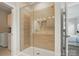 Modern shower with light-colored tile and glass door, with views to the connected laundry room at 1116 Brooksland Pl, Waxhaw, NC 28173