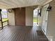 Cozy back porch with wooden floor and fan for relaxing outdoors at 116 Dove Ln, New London, NC 28127