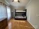 Spacious bedroom featuring a bunk bed, wood floors, and a dresser under soft natural lighting at 116 Dove Ln, New London, NC 28127