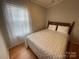 Cozy bedroom featuring a comfortable bed with soft bedding and bright natural light from a window at 116 Dove Ln, New London, NC 28127