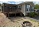 Charming home with a wooden deck, stone fire pit, and well-maintained landscaping at 116 Dove Ln, New London, NC 28127