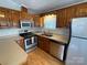 Well-equipped kitchen with wooden cabinets, stainless steel appliances, and plenty of counter space at 116 Dove Ln, New London, NC 28127