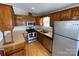 Beautiful kitchen featuring wooden cabinetry, stainless steel appliances, and laminate flooring at 116 Dove Ln, New London, NC 28127