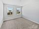 Bright bedroom with carpet and two windows providing ample natural light at 11933 Silverheel Ln, Huntersville, NC 28078