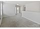 A spacious bonus room with neutral walls, carpet, and multiple doorways at 11933 Silverheel Ln, Huntersville, NC 28078