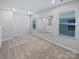 Bonus room with wall mirror, carpet, neutral walls, and natural light from two windows at 11933 Silverheel Ln, Huntersville, NC 28078