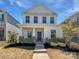 Charming two-story home with a welcoming front porch and well-maintained landscaping at 11933 Silverheel Ln, Huntersville, NC 28078