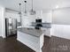 Modern kitchen with stainless steel appliances, sleek countertops, and a central island at 11933 Silverheel Ln, Huntersville, NC 28078
