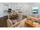 Bright, open-concept living space with modern furnishings and hardwood floors at 11933 Silverheel Ln, Huntersville, NC 28078