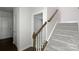Clean and carpeted staircase with white walls and a wooden handrail at 11933 Silverheel Ln, Huntersville, NC 28078