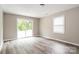 Bright bedroom featuring stylish wood-look flooring and a sliding glass door to the backyard at 1204 Glenarden Dr, Rock Hill, SC 29730