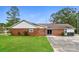 Brick home with well-manicured lawn, driveway, and mature trees at 1204 Glenarden Dr, Rock Hill, SC 29730