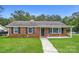 Charming brick ranch-style home with a well-manicured front yard and inviting covered porch at 1204 Glenarden Dr, Rock Hill, SC 29730