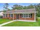 Charming brick ranch-style home with a well-manicured front yard and inviting covered porch at 1204 Glenarden Dr, Rock Hill, SC 29730