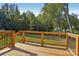 Wooden back deck with dark metal railings overlooks a green lawn and trees at 122 Laura Rd # A, Mooresville, NC 28117
