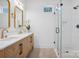 Modern bathroom with a double vanity, decorative tiling, and a glass-enclosed shower at 122 Laura Rd # A, Mooresville, NC 28117
