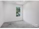 Bright and airy bedroom with a large window offering views of lush greenery at 122 Laura Rd # A, Mooresville, NC 28117