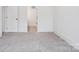 Spacious room showing entry to en suite bathroom; neutral tone and polished concrete floor at 122 Laura Rd # A, Mooresville, NC 28117