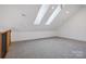 Bonus room has carpet flooring, skylights, recessed lighting, railing, and neutral paint at 122 Laura Rd # A, Mooresville, NC 28117