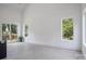 Bright living room with large windows, open floor plan, and access to outdoor deck at 122 Laura Rd # A, Mooresville, NC 28117