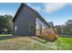 Back exterior of a home with dark siding, metal roof, and a wooden deck at 122 Laura Rd # A, Mooresville, NC 28117
