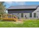 Home with black siding and metal roof, AC units, and a small wooden deck at 122 Laura Rd # A, Mooresville, NC 28117