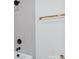 Modern bathroom showcasing a tiled shower with matte black fixtures and a sleek gold towel rack at 122 Laura Rd # B, Mooresville, NC 28117