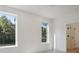 Bright bedroom featuring two large windows overlooking lush trees and a walk-in shower at 122 Laura Rd # B, Mooresville, NC 28117