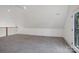 Bright bonus room with gray carpeting, lots of natural light and a balcony overlooking the main floor at 122 Laura Rd # B, Mooresville, NC 28117