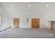 Spacious bonus room with a gray carpet, neutral walls, access to storage and a balcony railing at 122 Laura Rd # B, Mooresville, NC 28117