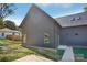 Modern home featuring a metal roof and landscaped grounds with a concrete patio at 122 Laura Rd # B, Mooresville, NC 28117