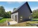 Modern home with a dark gray exterior, metal roof, and small patio area next to a freshly seeded lawn at 122 Laura Rd # B, Mooresville, NC 28117