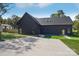 Modern home featuring a metal roof and a spacious concrete driveway with landscaped front yard at 122 Laura Rd # B, Mooresville, NC 28117