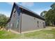 Modern house with a dark gray exterior, sleek lines, and a well-manicured lawn at 122 Laura Rd # B, Mooresville, NC 28117