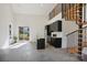 Open-concept space with black kitchen cabinets, a modern island, and a unique spiral staircase at 122 Laura Rd # B, Mooresville, NC 28117